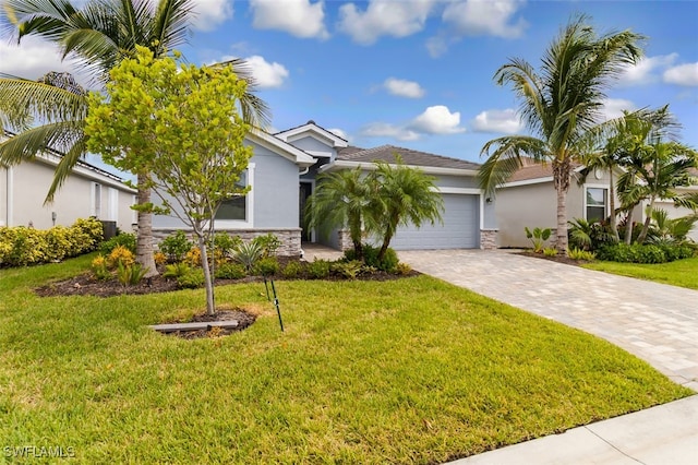 9760 Mirada Blvd, Fort Myers, FL 33908 - view of front of property with stucco siding, decorative driveway, stone siding, and an attached garage
