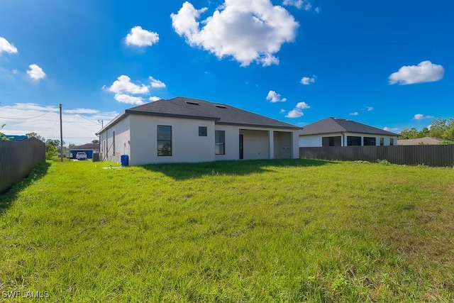 3209 22nd St SW, Lehigh Acres, FL 33976 - rear view of property featuring stucco siding