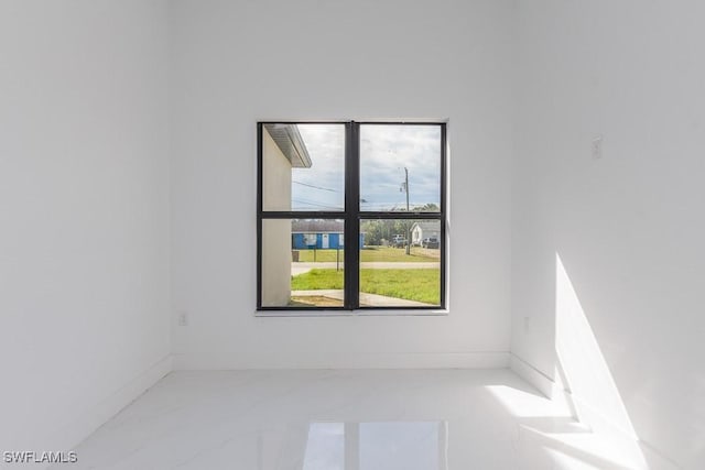 3209 22nd St SW, Lehigh Acres, FL 33976 - unfurnished room featuring marble finish floors and baseboards