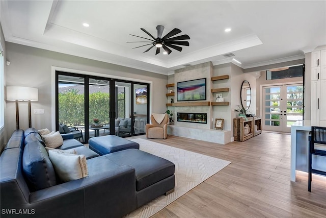 234 Legacy Ct, Naples, FL 34110 - living area with a raised ceiling, ceiling fan, ornamental molding, plenty of natural light, and french doors
