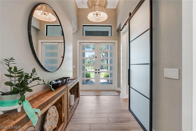 234 Legacy Ct, Naples, FL 34110 - entryway featuring french doors, wood finished floors, and a barn door