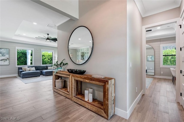 234 Legacy Ct, Naples, FL 34110 - corridor with light wood-style flooring, a tray ceiling, healthy amount of natural light, recessed lighting, and crown molding