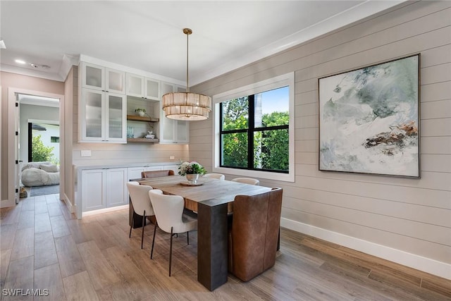 234 Legacy Ct, Naples, FL 34110 - dining area featuring light wood-type flooring, wood walls, recessed lighting, and ornamental molding