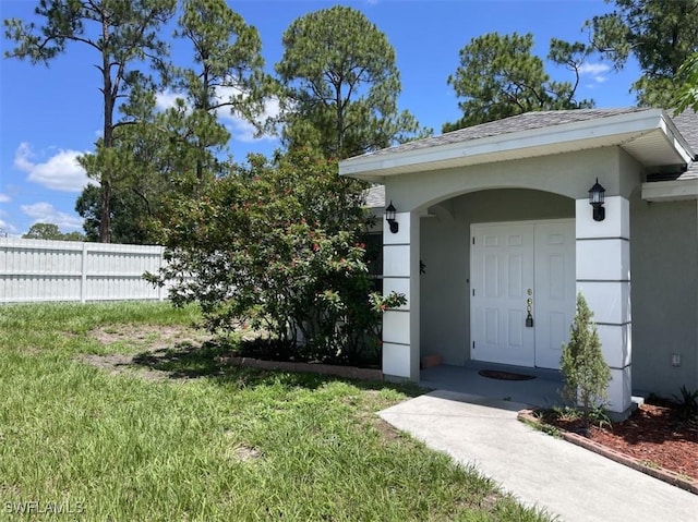 200 W 17th St, Lehigh Acres, FL 33972 - view of exterior entry with stucco siding