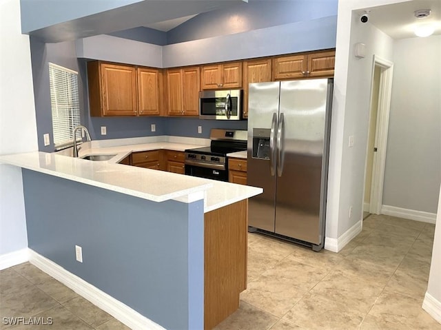200 W 17th St, Lehigh Acres, FL 33972 - kitchen featuring stainless steel appliances, a peninsula, light countertops, and brown cabinets