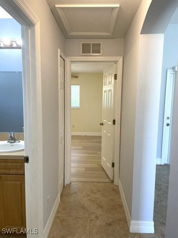 200 W 17th St, Lehigh Acres, FL 33972 - corridor with light tile patterned floors and arched walkways