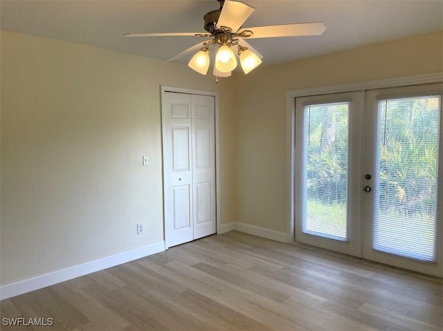 200 W 17th St, Lehigh Acres, FL 33972 - empty room featuring french doors, light wood-type flooring, and ceiling fan