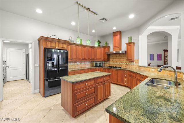 5251 Westminster Dr, Fort Myers, FL 33919 - kitchen featuring black refrigerator with ice dispenser, light tile patterned floors, decorative backsplash, gas cooktop, and stone counters
