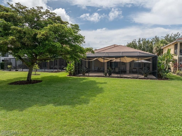 12455 Muddy Creek Ln, Fort Myers, FL 33913 - view of green lawn featuring a patio area and glass enclosure