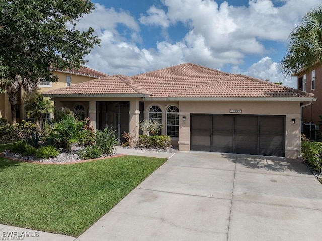 12455 Muddy Creek Ln, Fort Myers, FL 33913 - view of front facade featuring driveway, stucco siding, a garage, a front lawn, and a tile roof