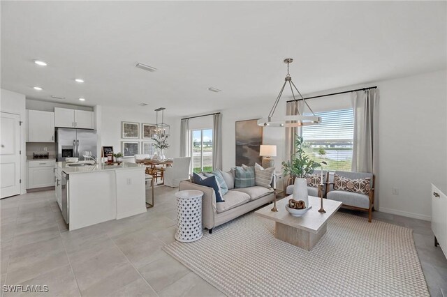 17251 Monte Isola Way N, Fort Myers, FL 33917 - living area with a chandelier, recessed lighting, and light tile patterned floors