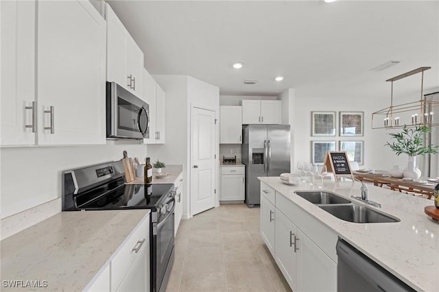 17251 Monte Isola Way N, Fort Myers, FL 33917 - kitchen featuring stainless steel appliances, white cabinets, light stone countertops, recessed lighting, and hanging light fixtures