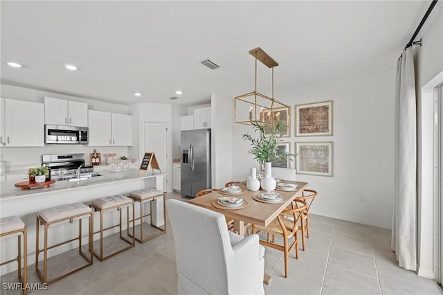 17251 Monte Isola Way N, Fort Myers, FL 33917 - dining space featuring a chandelier, light tile patterned flooring, and recessed lighting
