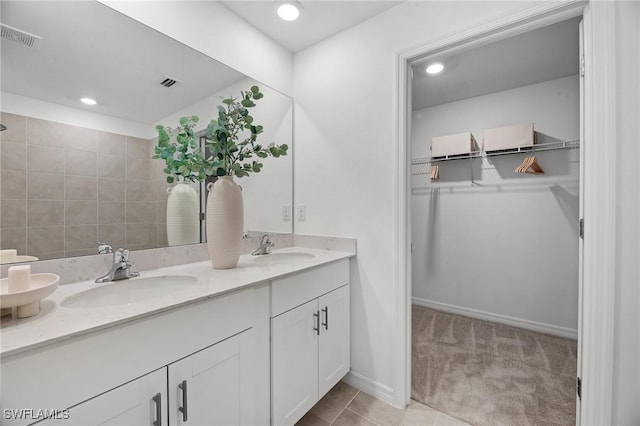 17251 Monte Isola Way N, Fort Myers, FL 33917 - bathroom with double vanity, a spacious closet, and recessed lighting