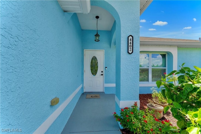 4402 Ruth Ave S, Lehigh Acres, FL 33976 - view of exterior entry featuring stucco siding