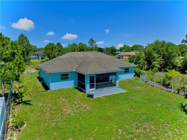 4402 Ruth Ave S, Lehigh Acres, FL 33976 - rear view of house featuring a sunroom, stucco siding, and view of wooded area