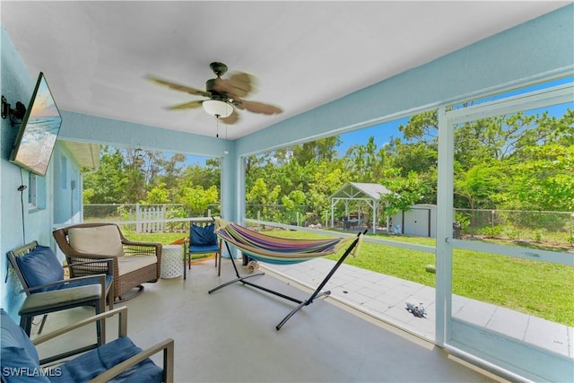 4402 Ruth Ave S, Lehigh Acres, FL 33976 - sunroom / solarium with ceiling fan, plenty of natural light, and view of wooded area