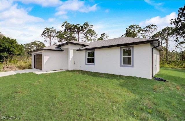 2613 73rd St W, Lehigh Acres, FL 33971 - rear view of house featuring stucco siding, an attached garage, a yard, and concrete driveway