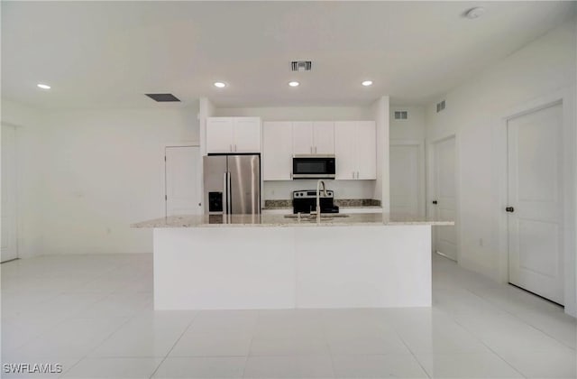 2613 73rd St W, Lehigh Acres, FL 33971 - kitchen featuring stainless steel appliances, an island with sink, light stone countertops, white cabinetry, and recessed lighting