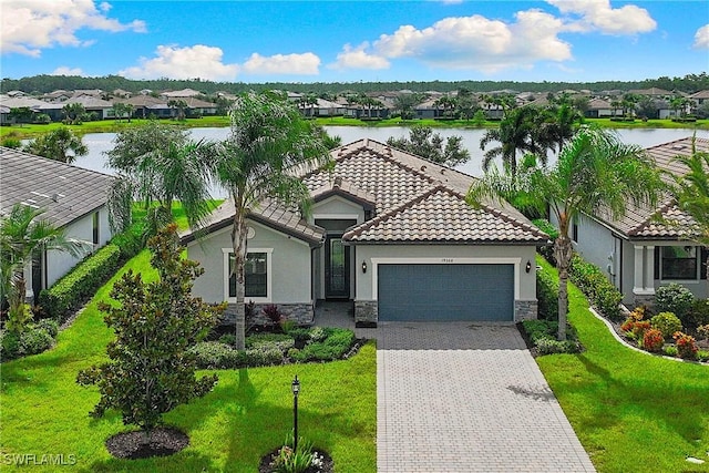 19368 Elston Way, Estero, FL 33928 - view of front facade featuring stone siding, a residential view, an attached garage, a water view, and stucco siding