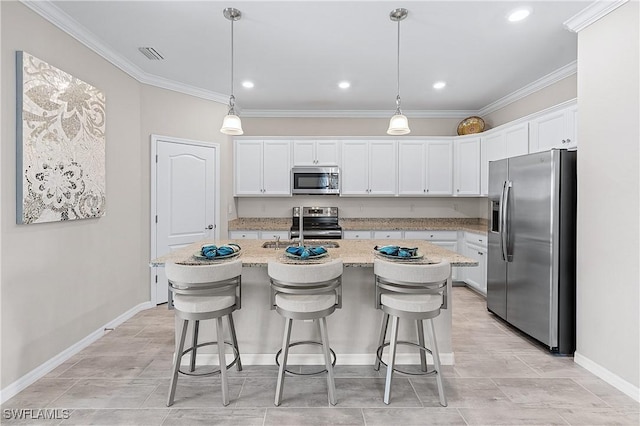 19368 Elston Way, Estero, FL 33928 - kitchen with stainless steel appliances, white cabinets, ornamental molding, an island with sink, and light stone countertops