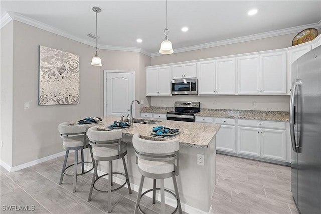 19368 Elston Way, Estero, FL 33928 - kitchen with stainless steel appliances, ornamental molding, white cabinets, light stone counters, and an island with sink