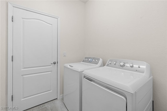 19368 Elston Way, Estero, FL 33928 - washroom with washing machine and clothes dryer and light wood-style flooring