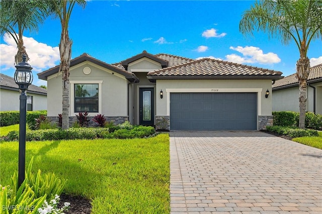 19368 Elston Way, Estero, FL 33928 - mediterranean / spanish-style home featuring stone siding, a garage, stucco siding, a front lawn, and decorative driveway