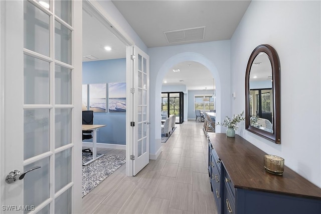 19387 Elston Way, Estero, FL 33928 - hallway featuring french doors and arched walkways