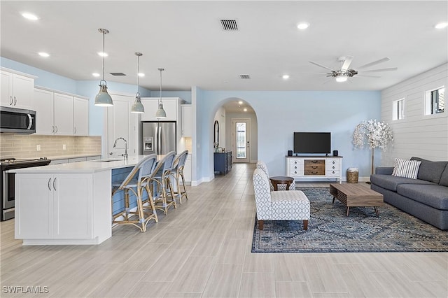 19387 Elston Way, Estero, FL 33928 - living room featuring arched walkways, ceiling fan, recessed lighting, and healthy amount of natural light