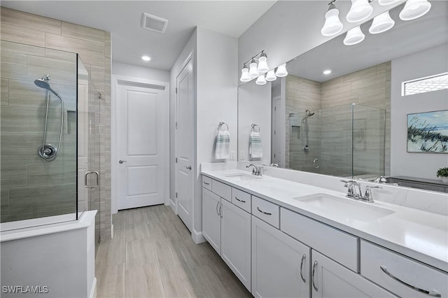 19387 Elston Way, Estero, FL 33928 - bathroom with a stall shower, double vanity, a chandelier, and recessed lighting