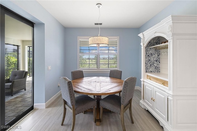 19387 Elston Way, Estero, FL 33928 - dining room with light wood-type flooring and baseboards