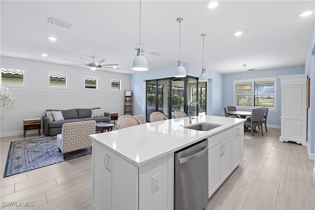 19387 Elston Way, Estero, FL 33928 - kitchen with dishwasher, light countertops, an island with sink, white cabinets, and pendant lighting