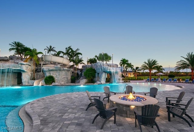 19387 Elston Way, Estero, FL 33928 - community pool featuring a water slide, an outdoor fire pit, and a patio