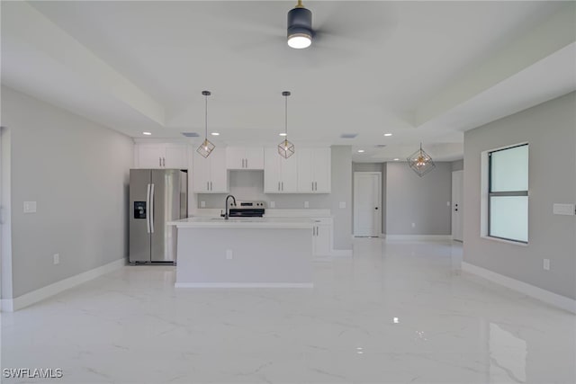 3709 6th St SW, Lehigh Acres, FL 33976 - kitchen with stainless steel fridge, a kitchen island with sink, white cabinetry, light marble finish flooring, and recessed lighting