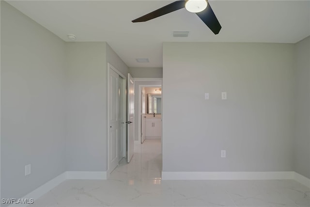 3709 6th St SW, Lehigh Acres, FL 33976 - empty room with light marble finish floors, a ceiling fan, and a smoke detector