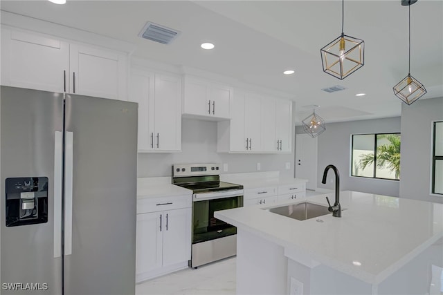 3709 6th St SW, Lehigh Acres, FL 33976 - kitchen with stainless steel appliances, a kitchen island with sink, white cabinetry, recessed lighting, and decorative light fixtures