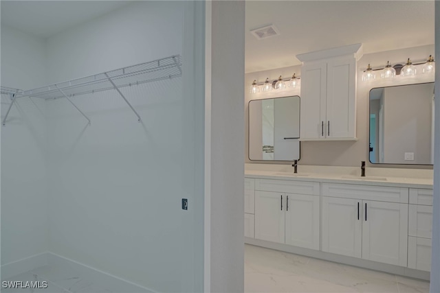 3709 6th St SW, Lehigh Acres, FL 33976 - full bathroom with marble look tile flooring, double vanity, and a walk in closet