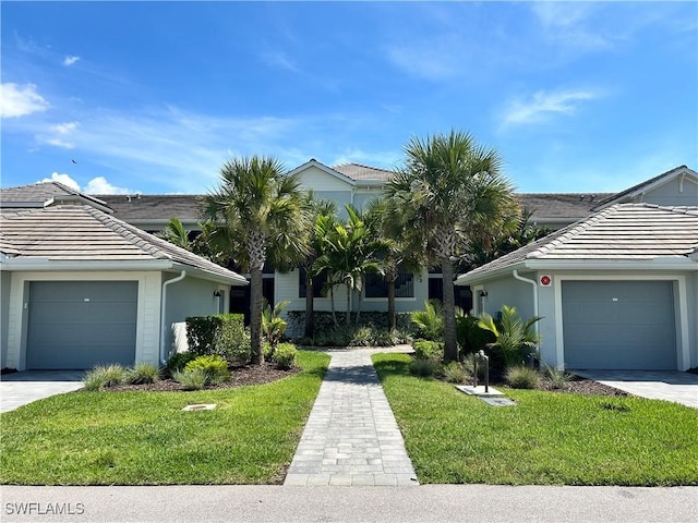 6023 Ellerston Way Unit 1825, Ave Maria, FL 34142 - view of front of property featuring a tile roof, a front lawn, and stucco siding