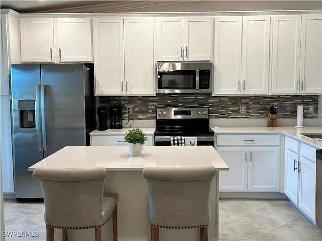 6023 Ellerston Way Unit 1825, Ave Maria, FL 34142 - kitchen featuring stainless steel appliances, light countertops, backsplash, and white cabinets