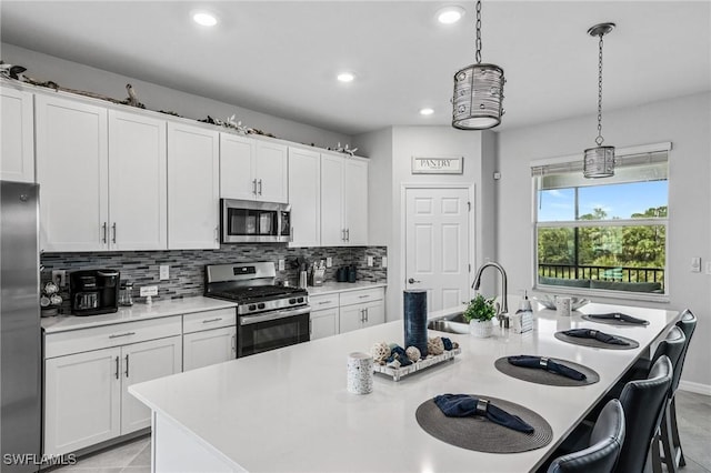 43301 Water Bird Way Unit 5221, Punta Gorda, FL 33982 - kitchen with appliances with stainless steel finishes, a kitchen island with sink, tasteful backsplash, light countertops, and recessed lighting