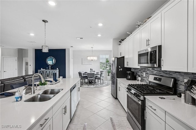 43301 Water Bird Way Unit 5221, Punta Gorda, FL 33982 - kitchen featuring appliances with stainless steel finishes, light countertops, white cabinetry, tasteful backsplash, and recessed lighting