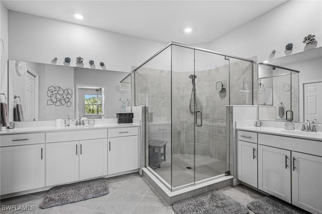 43301 Water Bird Way Unit 5221, Punta Gorda, FL 33982 - full bathroom featuring two vanities, a stall shower, recessed lighting, and tile patterned floors