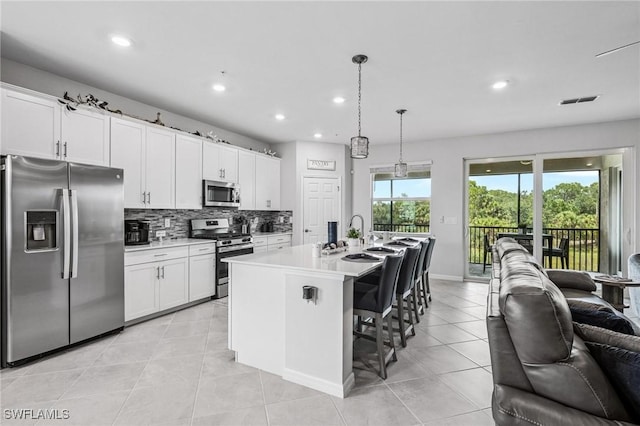 43301 Water Bird Way Unit 5221, Punta Gorda, FL 33982 - kitchen with stainless steel appliances, open floor plan, backsplash, recessed lighting, and light countertops