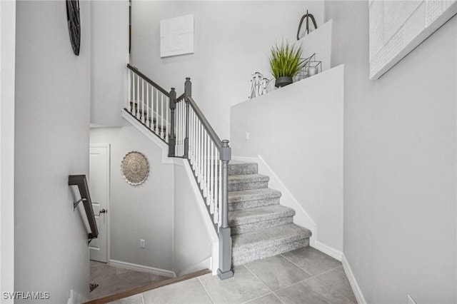 43301 Water Bird Way Unit 5221, Punta Gorda, FL 33982 - stairway with tile patterned floors and a towering ceiling