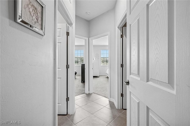 43301 Water Bird Way Unit 5221, Punta Gorda, FL 33982 - hallway with light carpet and light tile patterned flooring