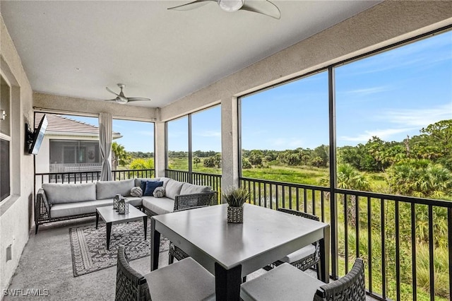 43301 Water Bird Way Unit 5221, Punta Gorda, FL 33982 - sunroom with a ceiling fan, an outdoor hangout area, and view of wooded area