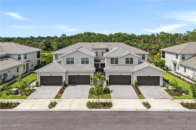 43301 Water Bird Way Unit 5221, Punta Gorda, FL 33982 - view of front facade featuring a tile roof, decorative driveway, and a garage