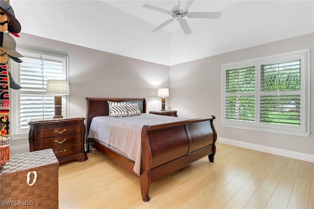 4323 Silver Fox Dr, Naples, FL 34119 - bedroom with light wood-style flooring, multiple windows, vaulted ceiling, and ceiling fan