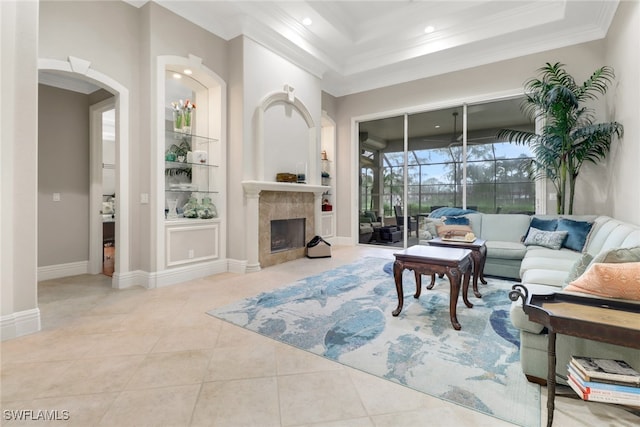 4323 Silver Fox Dr, Naples, FL 34119 - living room featuring crown molding, tile patterned floors, arched walkways, a high end fireplace, and recessed lighting
